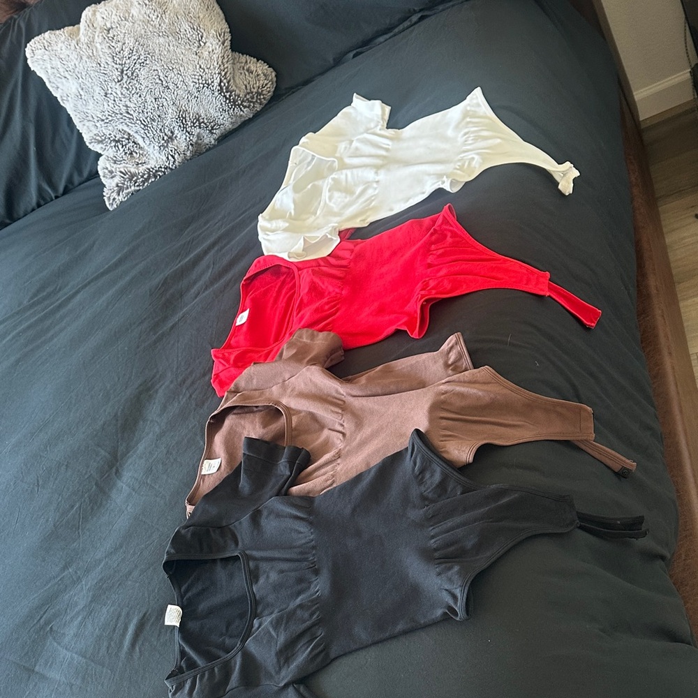 SKIMS Bodysuits in Black, Red, Brown, and White
